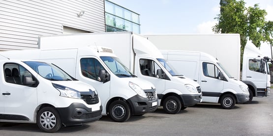Fleet of white trucks, vans and vehicles